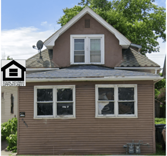 Small brown house with upstairs windows.
