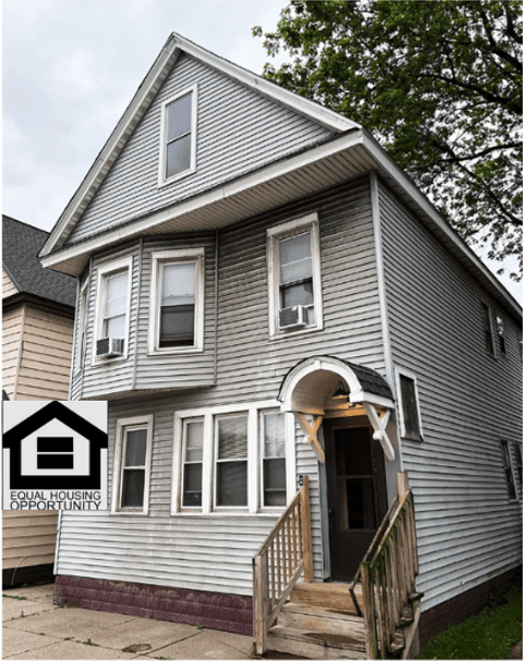Gray two-story house with equal housing logo.
